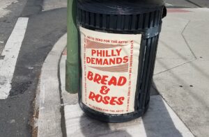 A Photo of a poster that says Philly Demands Bread and Roses